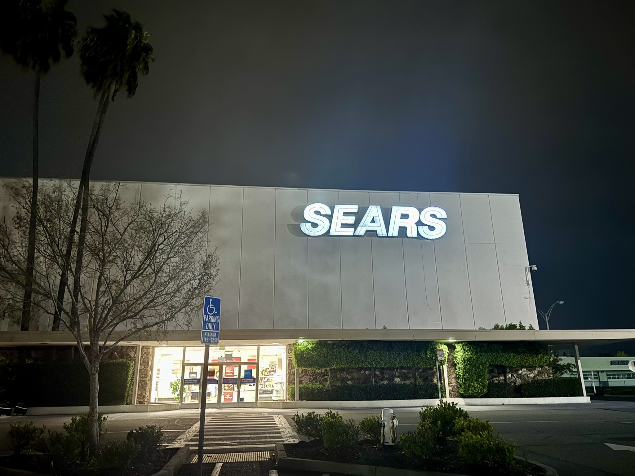 Old Sears sign lit against the night sky.