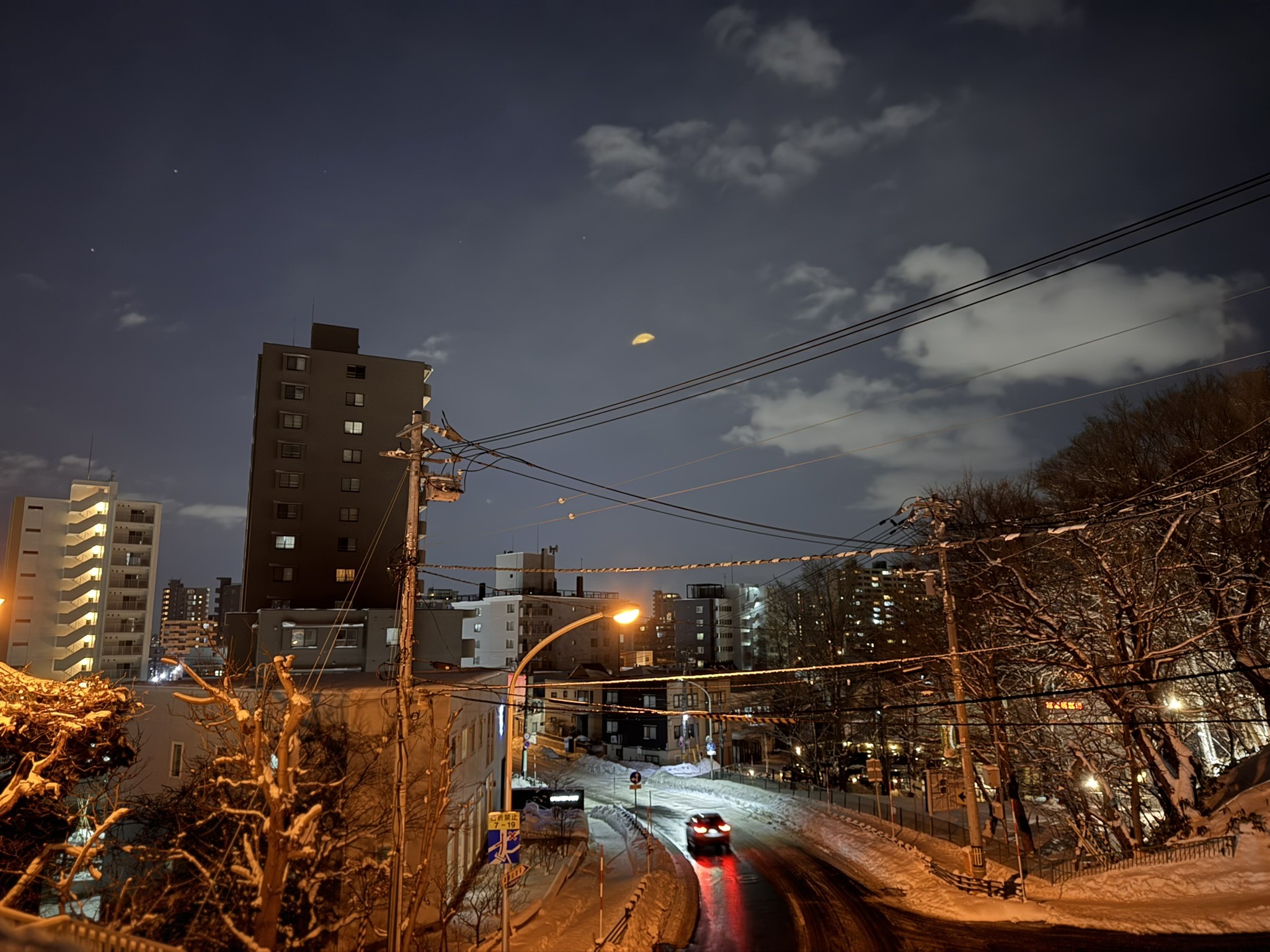 Urban skyline and street-level infrastructure in Japan at dusk.